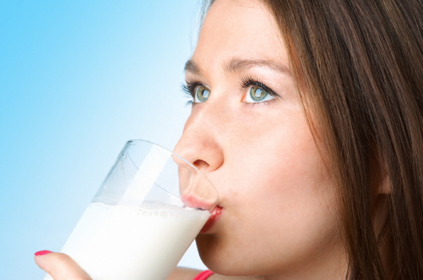 woman with glass milk on blue background